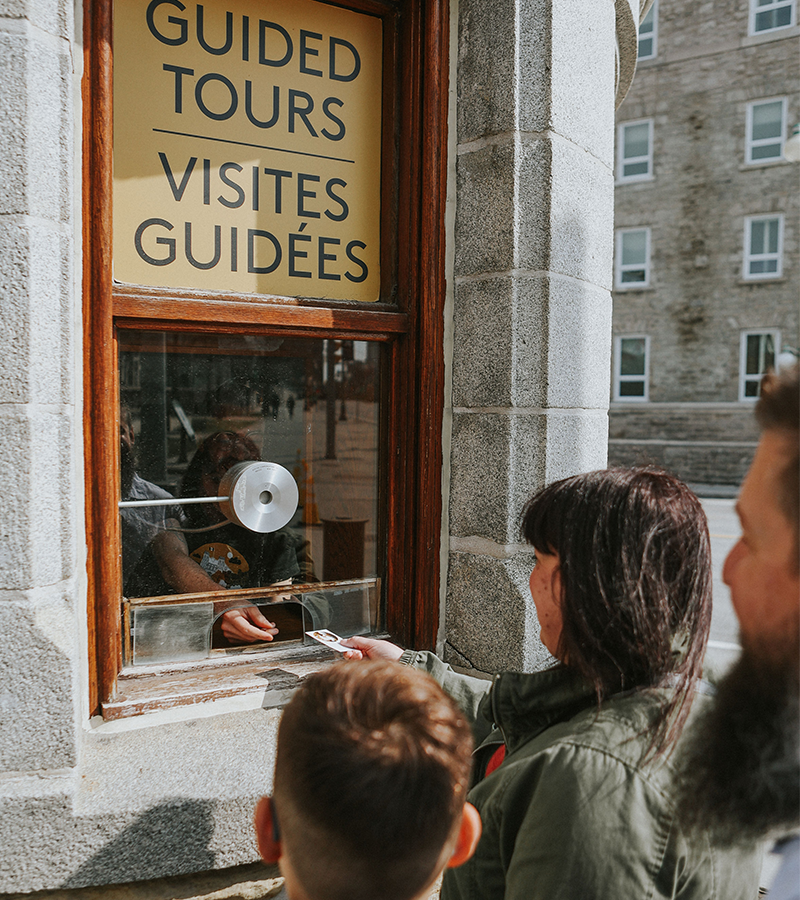 Photo of people buying Guided Tour tickets.