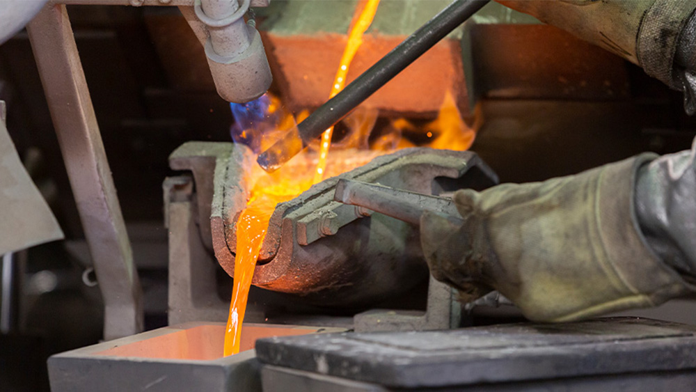 Photo of melted gold being poured.