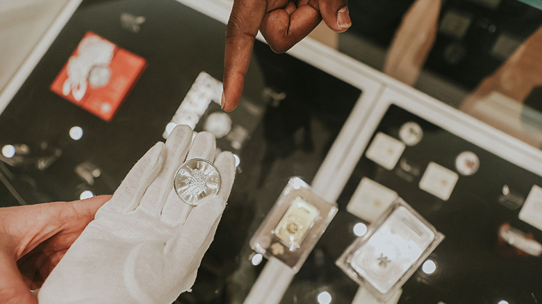 Person inspecting a coin