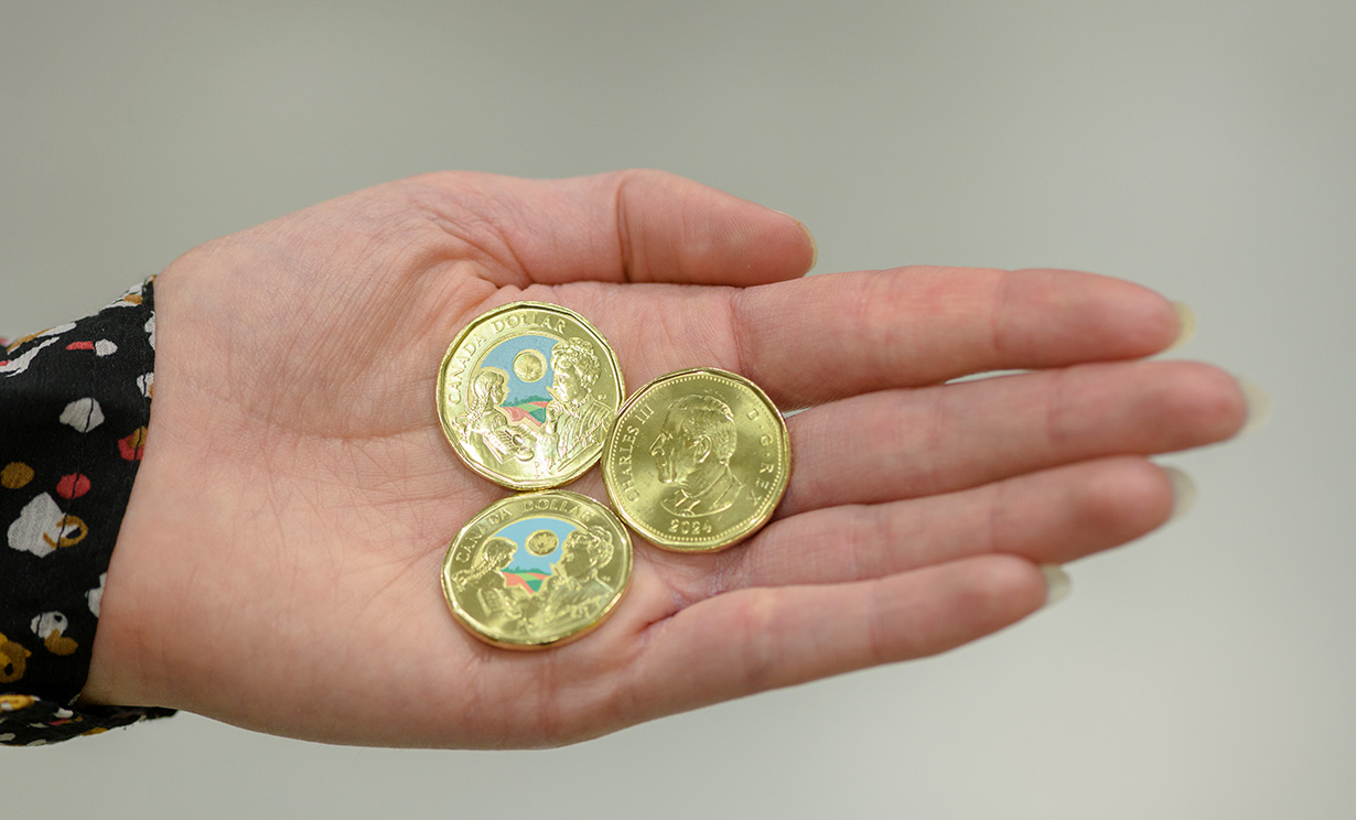 L. M. Montgomery commemorative circulation coin in hand