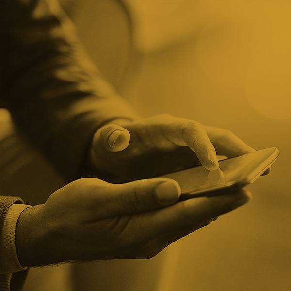 Photo of hands holding a phone.